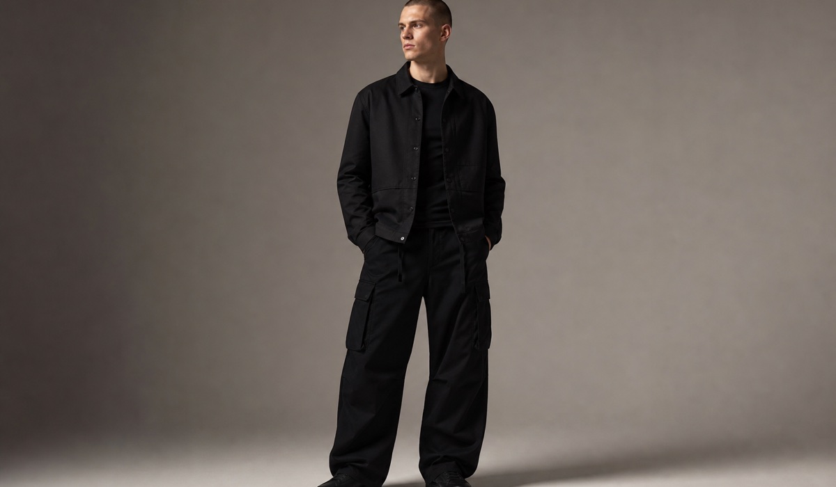 Wide black cargo trousers balanced by a structured upper layer